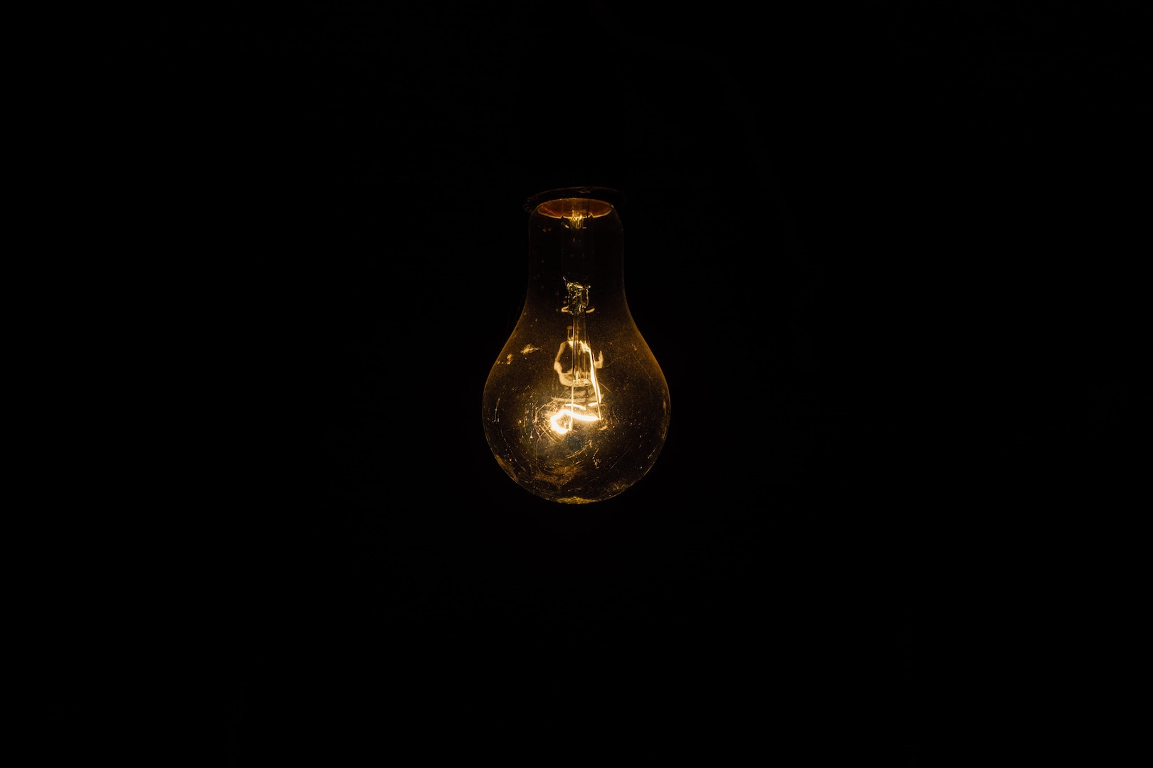 Image of lightbulb with black background.Prepare for TEDxMileHigh Rethink.